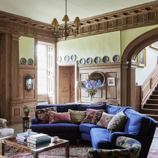 grand entrance hall with blue curved sofa in a Georgian home