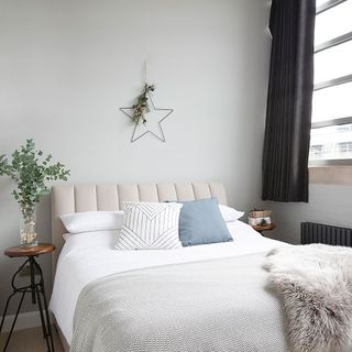 bedroom with white wall and window