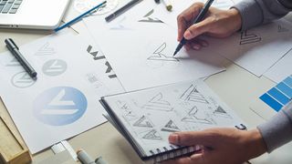 Logo design:Graphic designer drawing a sketch of a logo design