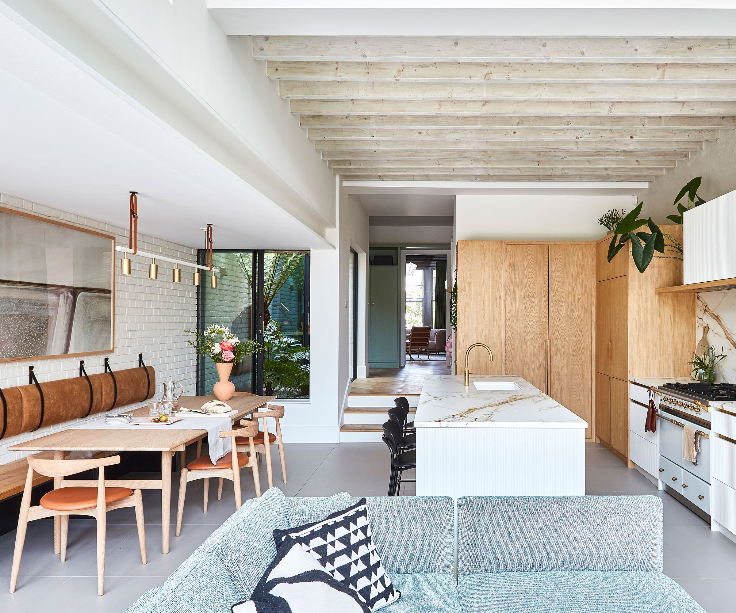 large open plan kitchen with banquette seating and living area