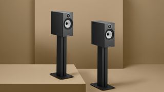 Bowers & Wilkins 606 S3 in black on stands a brown background