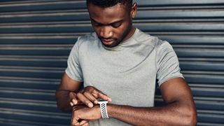 Man looks at his fitness tracker
