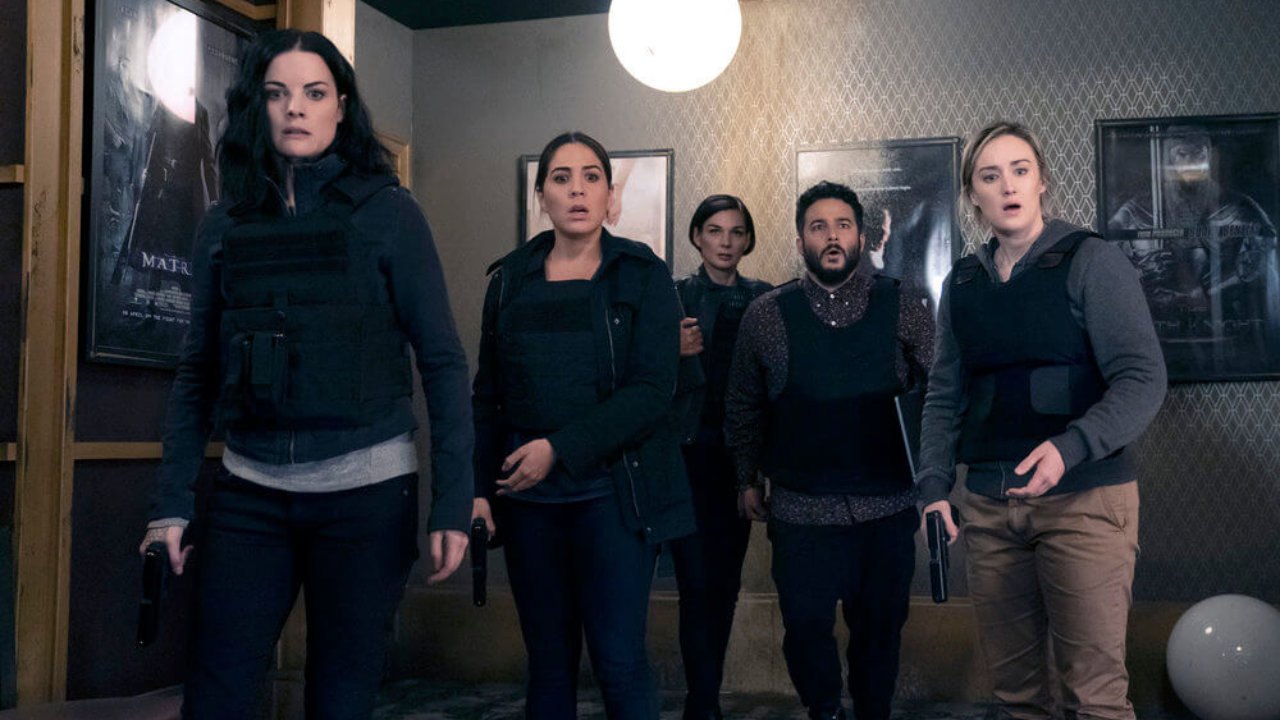 Five characters standing in a room and looking shocked in Blindspot