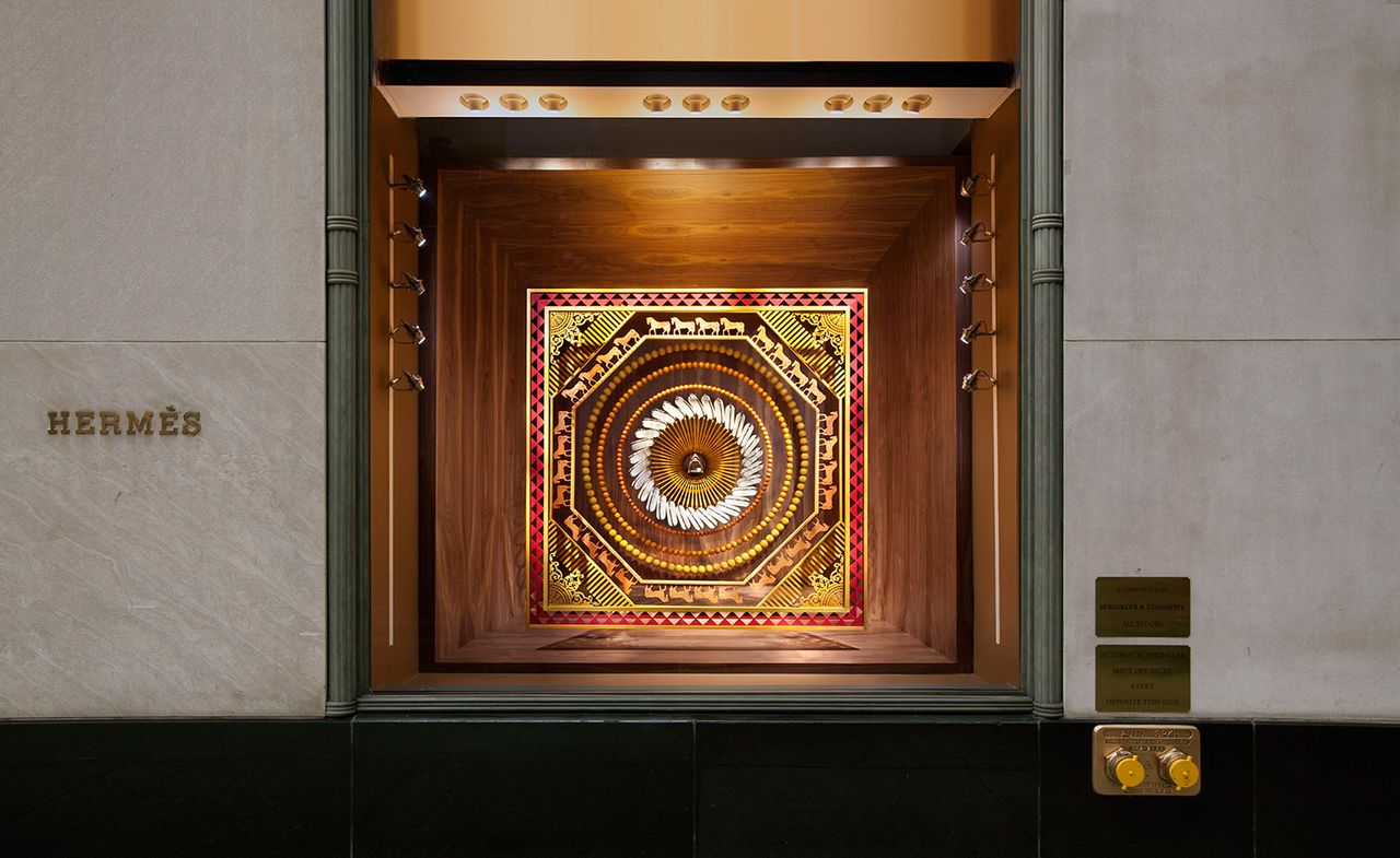 Autumnal window display of scarves for Hermès