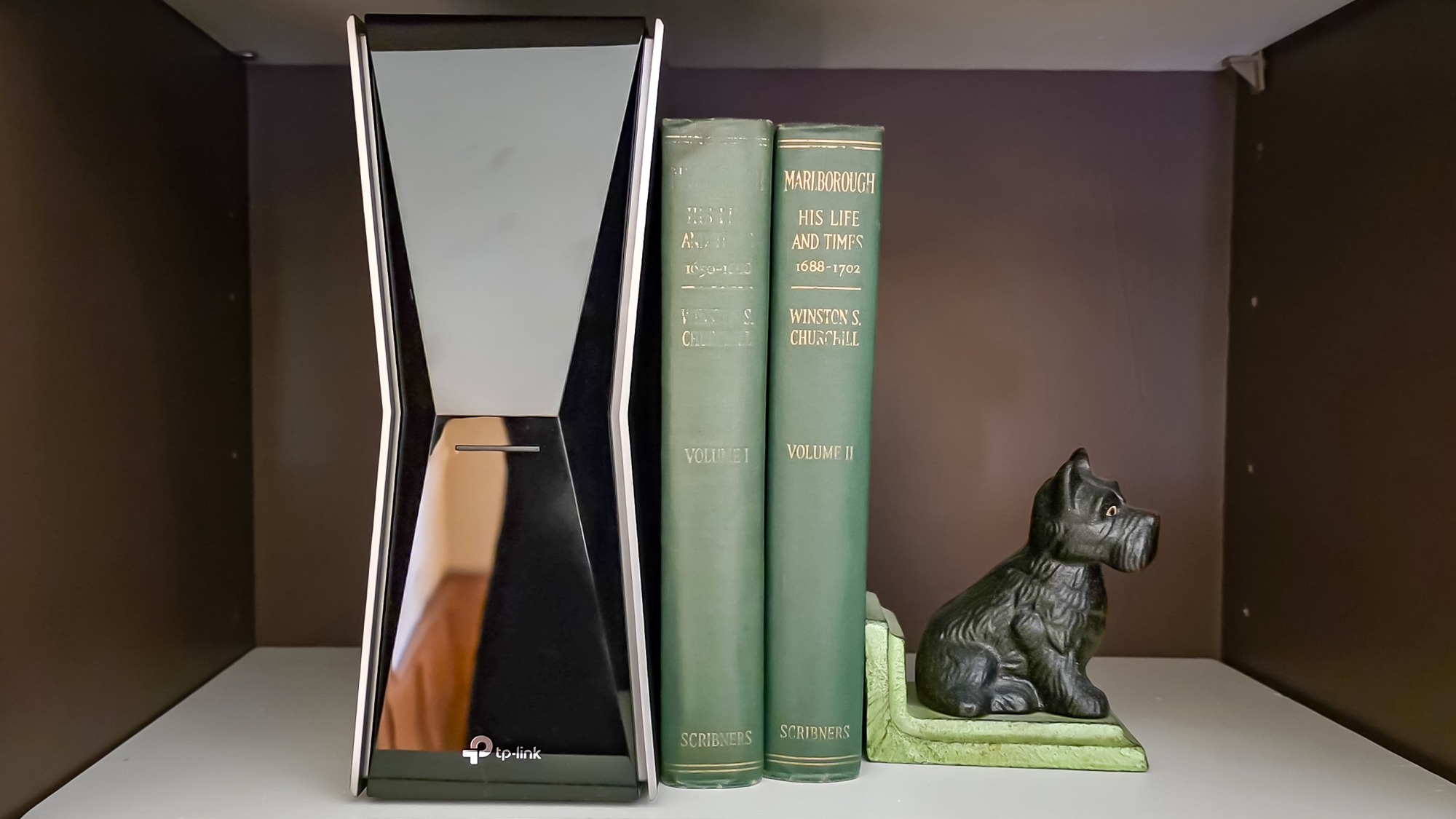 TP-Link Archer BE770 router on a shelf