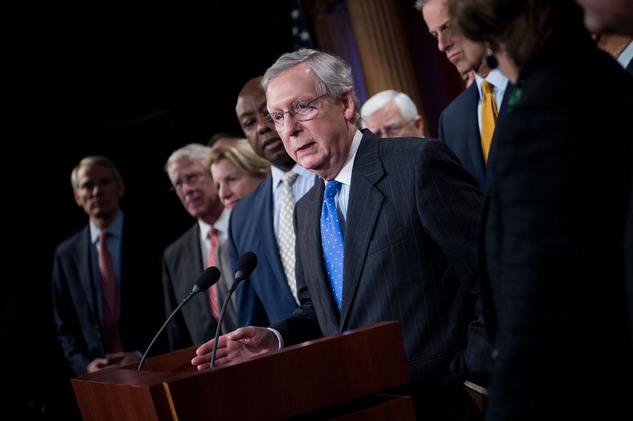 Mitch McConnell talks to the press after the Senate passes tax reform