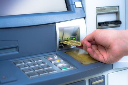 Person using ATM.