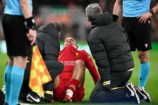 Liverpool's English defender #66 Trent Alexander-Arnold reacts following an injury during the last 16 second leg UEFA Champions League football match between Liverpool and Paris Saint-Germain (PSG) at Anfield in Liverpool, north west England on March 11, 2025. (Photo by Oli SCARFF / AFP) (Photo by OLI SCARFF/AFP via Getty Images)