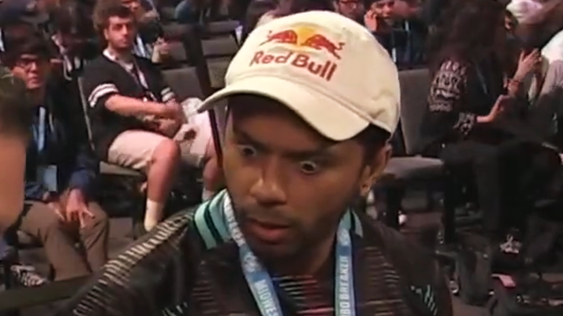 Arslan Ash staring down at Spero Gin (off-screen) in shock at him using a PS1 controller to play Tekken 8.