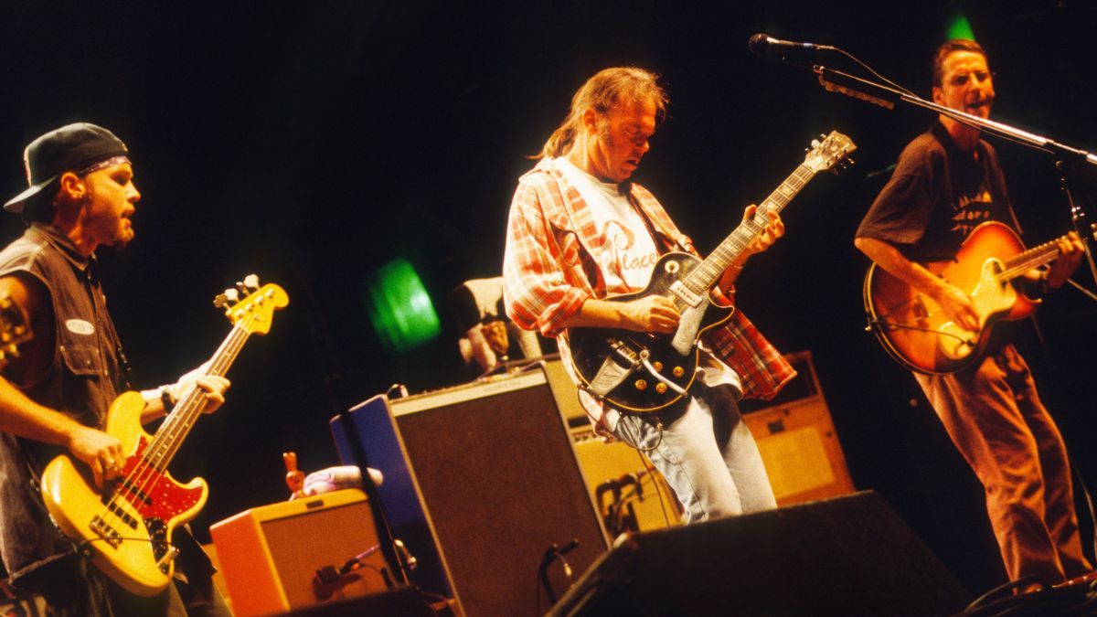 Neil Young and Pearl Jam perform on stage at Pukkelpop Festival, Hasselt, Belgium, 25th August 1995. L-R Jeff Ament, Neil Young, Stone Gossard