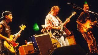 Neil Young and Pearl Jam perform on stage at Pukkelpop Festival, Hasselt, Belgium, 25th August 1995. L-R Jeff Ament, Neil Young, Stone Gossard