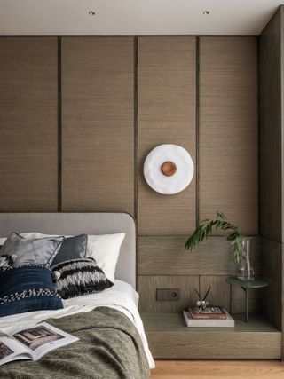 modern bedroom with neutral scheme, low side table, modern wall light