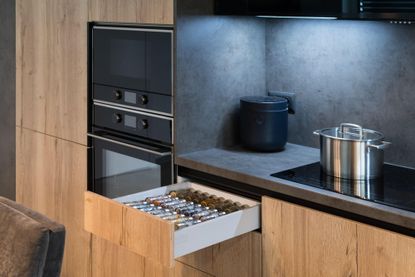 A modern kitchen with a spice drawer 