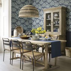 dining room with blue pattern wallpaper and rattan pendant shade