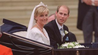 Prince Edward and Duchess Sophie leave in an open carriage following their wedding at St. George's Chapel on June 19, 1999