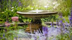 Water fountain in summer garden