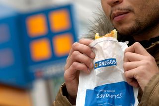 Man eating a Greggs bake