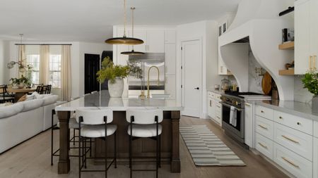 A white kitchen with a large kitchen island