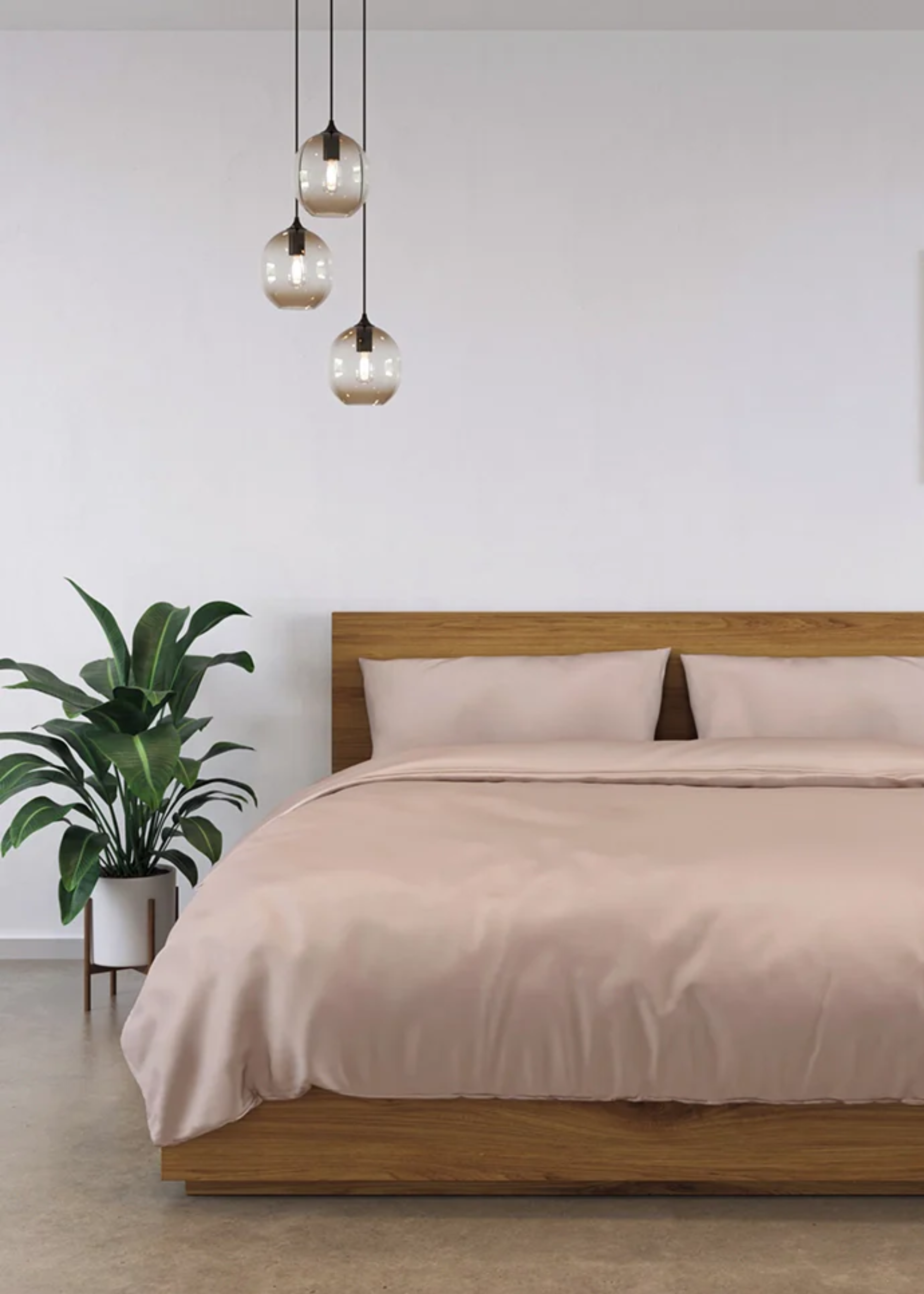 A pink bamboo bedset in a bedroom with pendant lights and a potted plant
