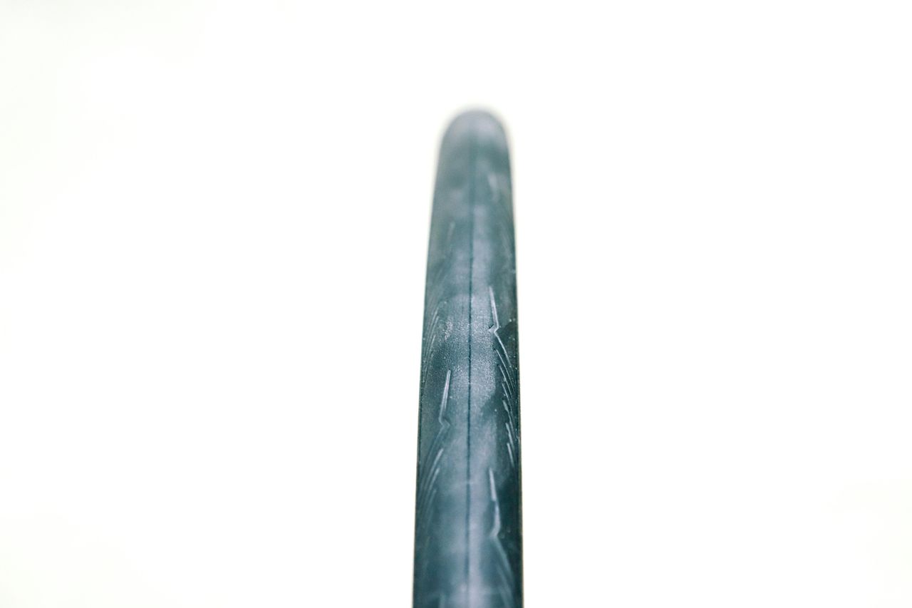 A close up of a black road bike tyre