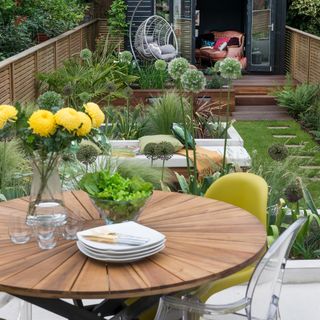 Terraced garden with wooden outdoor dining table
