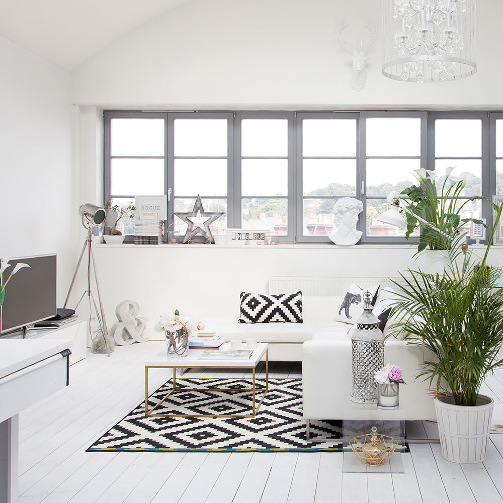 living room with white sofa and floor lamp and rug