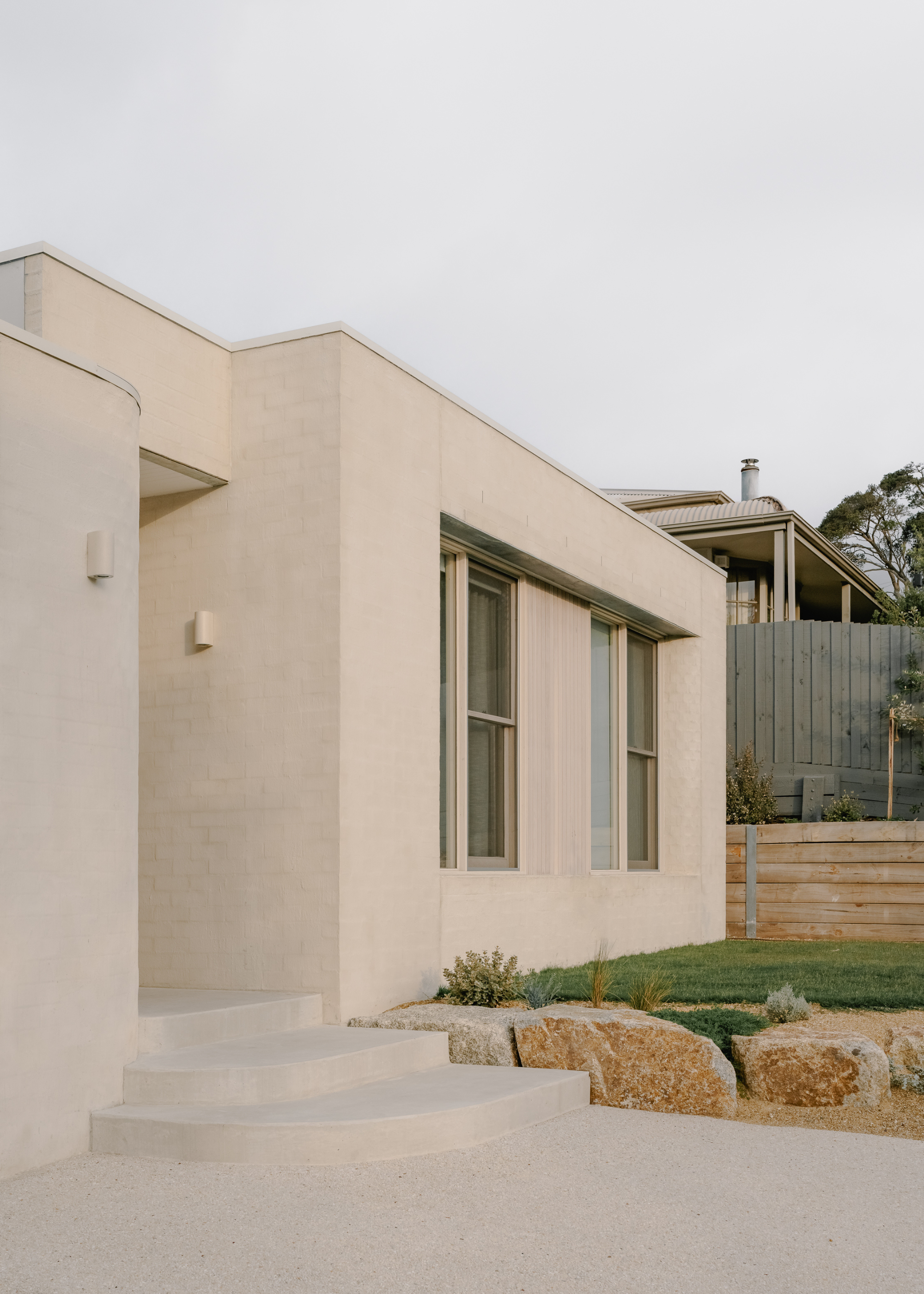 A home entry with a gray fence
