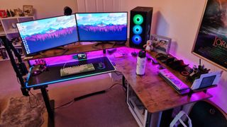 Fezibo Triple Motor L-Shaped Desk review image showing the desk with pink RGB lighting turned on
