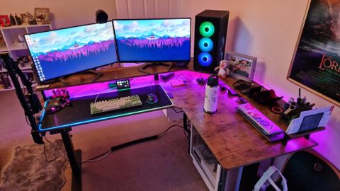 Fezibo Triple Motor L-Shaped Desk review image showing the desk with pink RGB lighting turned on