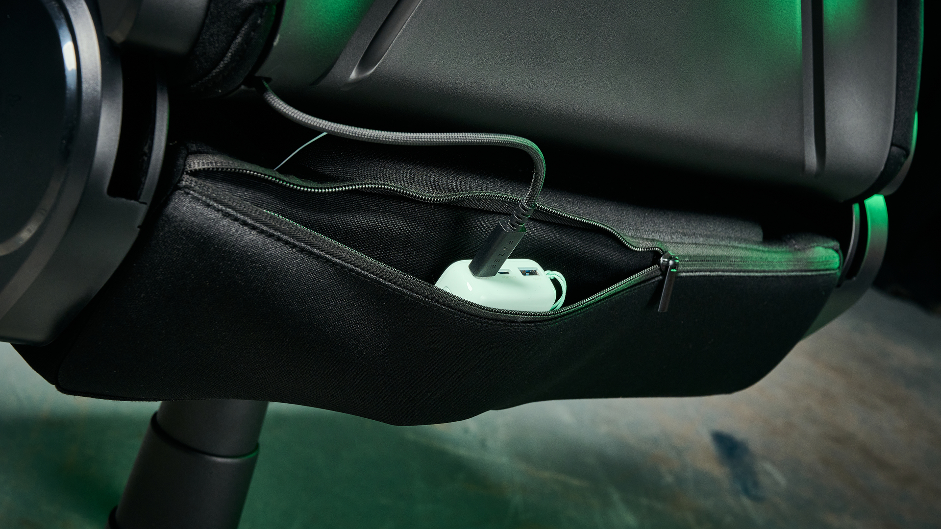 The Razer Soma Chroma chair with a power bank in its back pocket and plugged into its USB-C cable