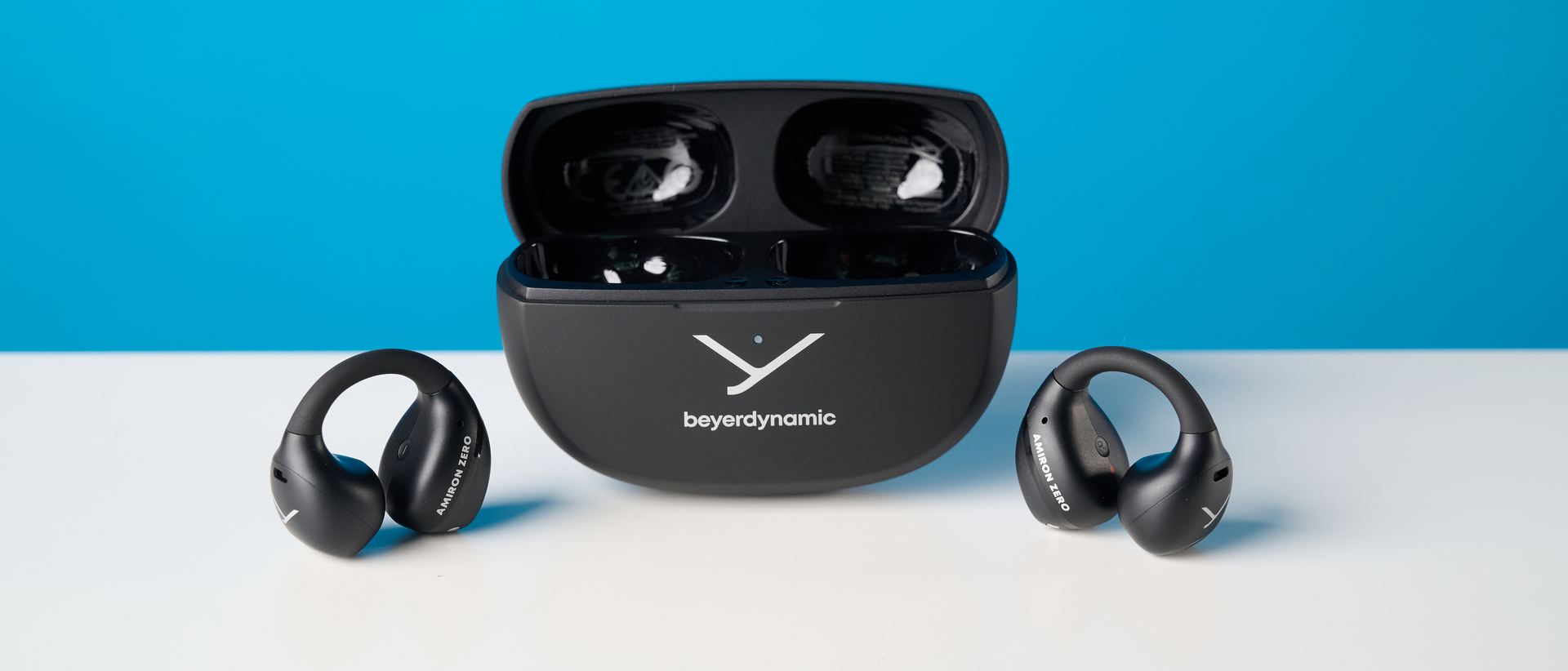 Beyerdynamic Amiron ZERO open-earbuds photographed on a blue background