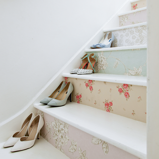 white stairs with floral wallpaper