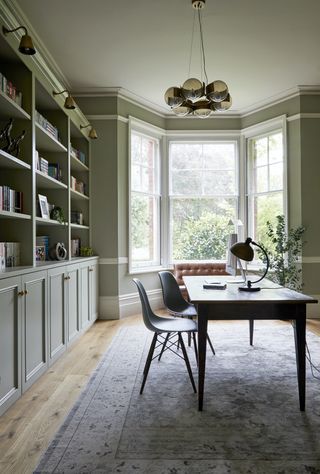 home office in French Gray with bay window and built-in shelving