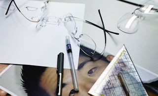 Architect Alvin Huang and Silhouette making eyewear frame design drawing on paper