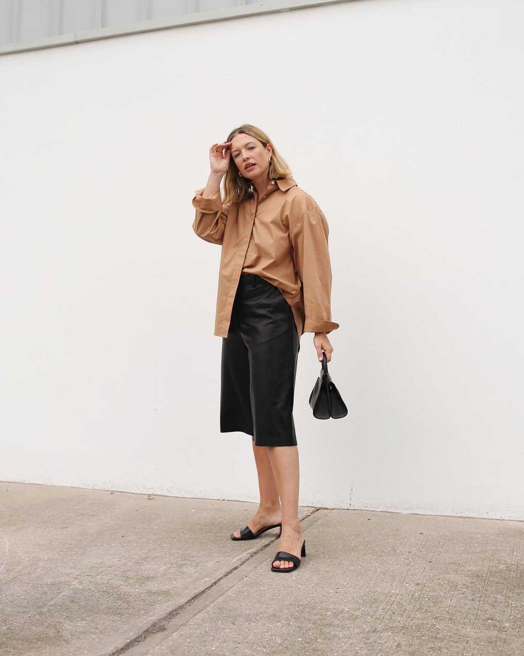 Alexis in leather shorts and mules