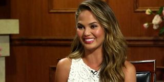 Chrissy Teigen smiling on Larry King interview