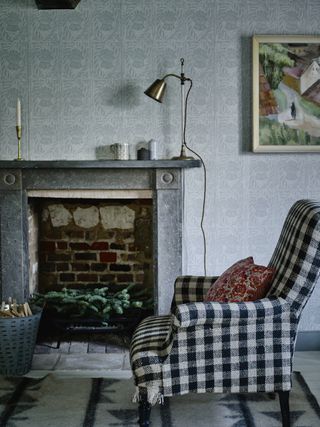 gingham armchair by fireplace