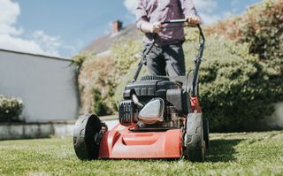 Close up of a man mowing his lawn