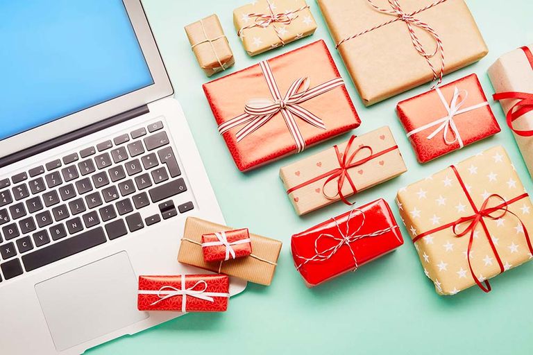 after Christmas sales - a selection of wrapped presents next to a laptop