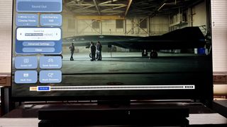 LG C3 OLED TV showing Top Gun Maverick on screen and Wow Orchestra mode adjustment