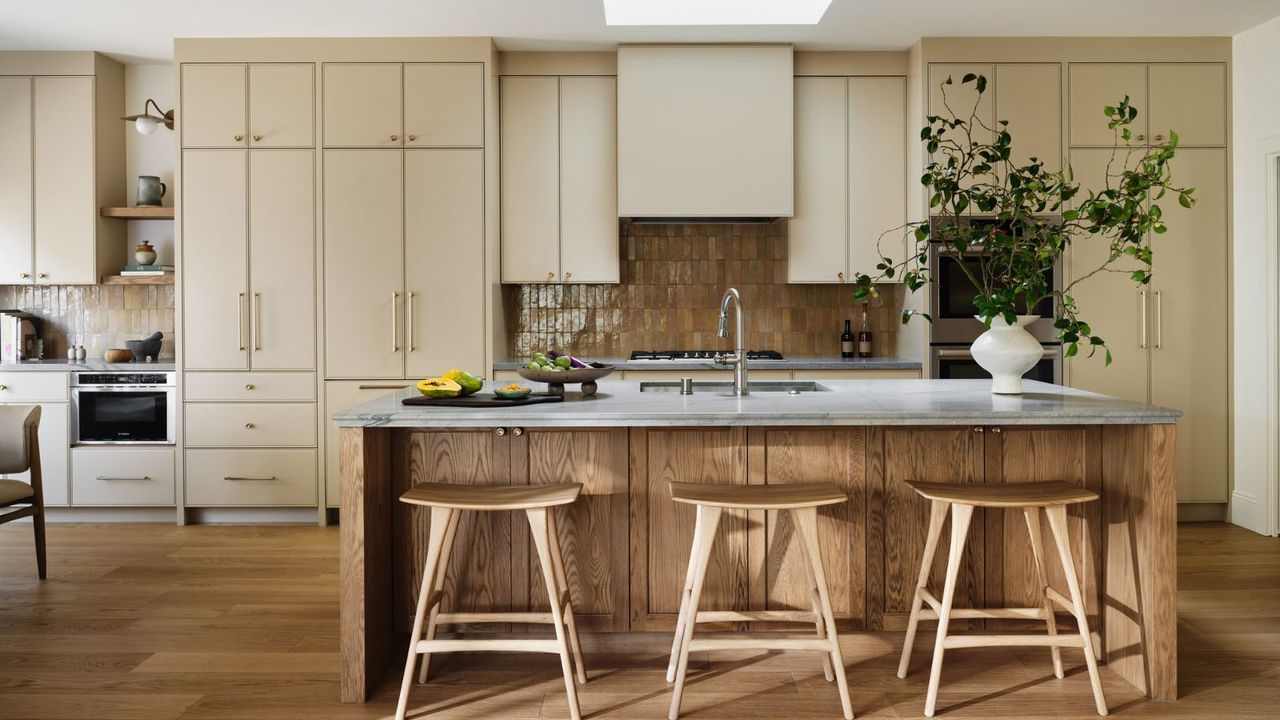 kitchen with wooden island and cream cabinetry