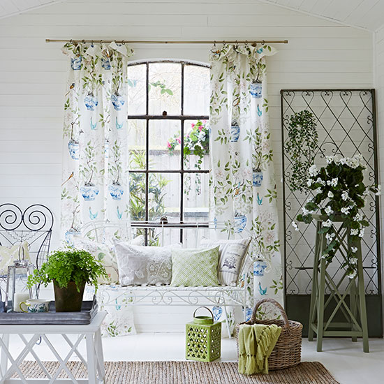 living area with white wall and curtain with wooden basket