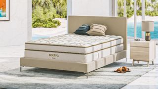 Image shows the Saatva Classic mattress placed on a bedframe with headboard