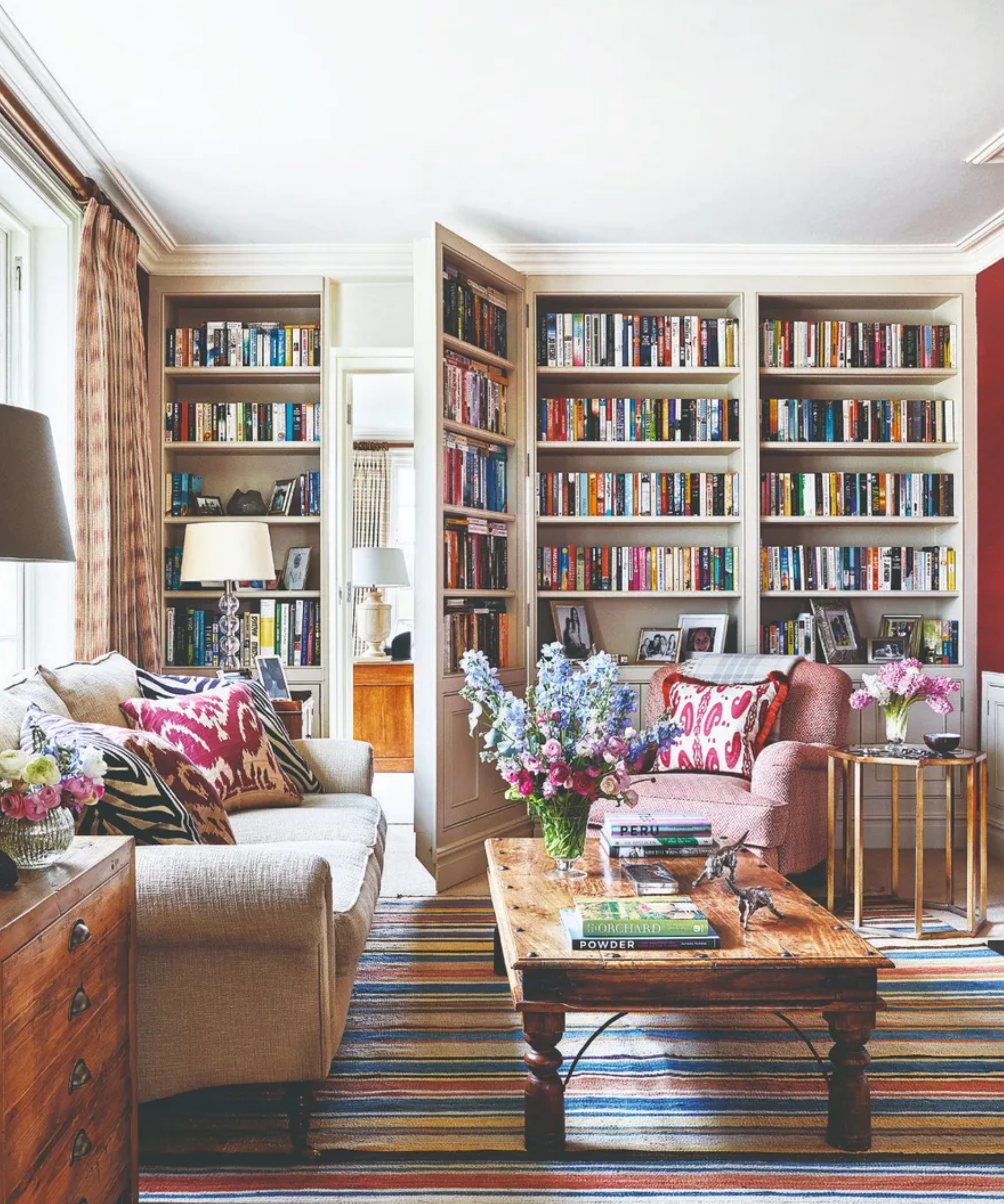 A hidden bookcase door in a library lounge