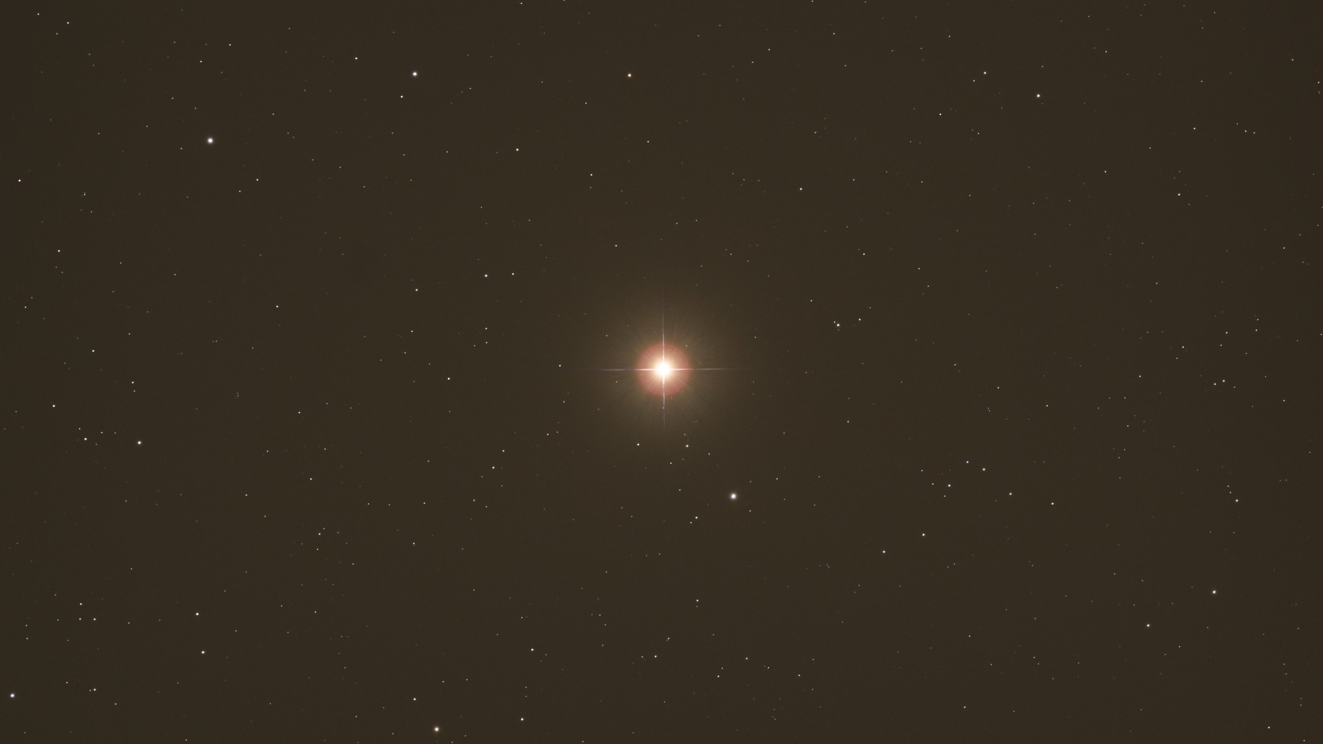 a bright red star in the night sky