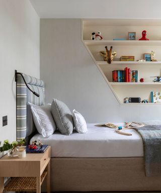 bedroom with shelves in sloping wall