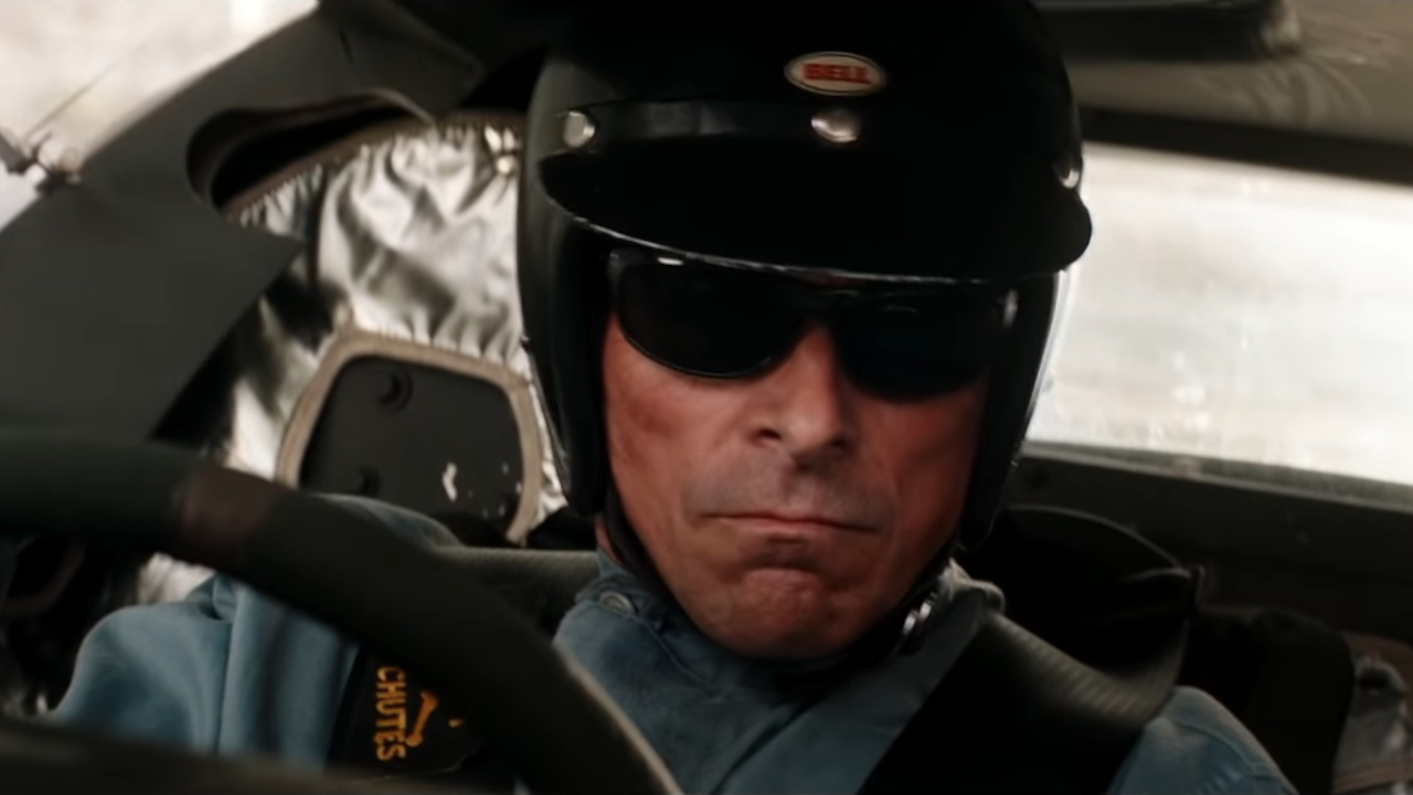 Christian Bale looks serious while driving a race car in Ford v.  Ferrari.