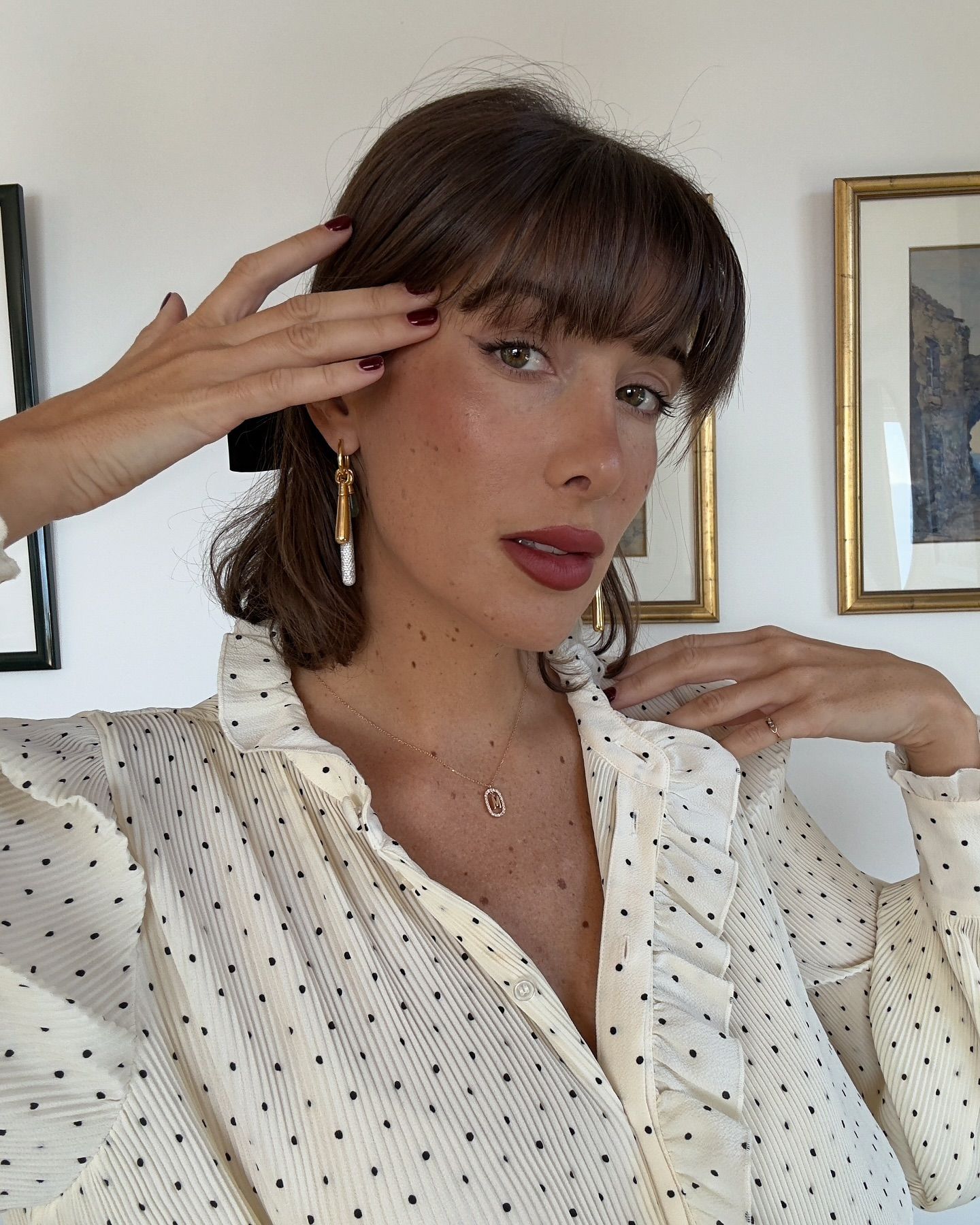 Influencer wears a polkadot blouse