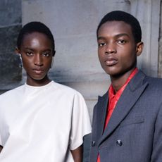 male and female models backstage at fashion week