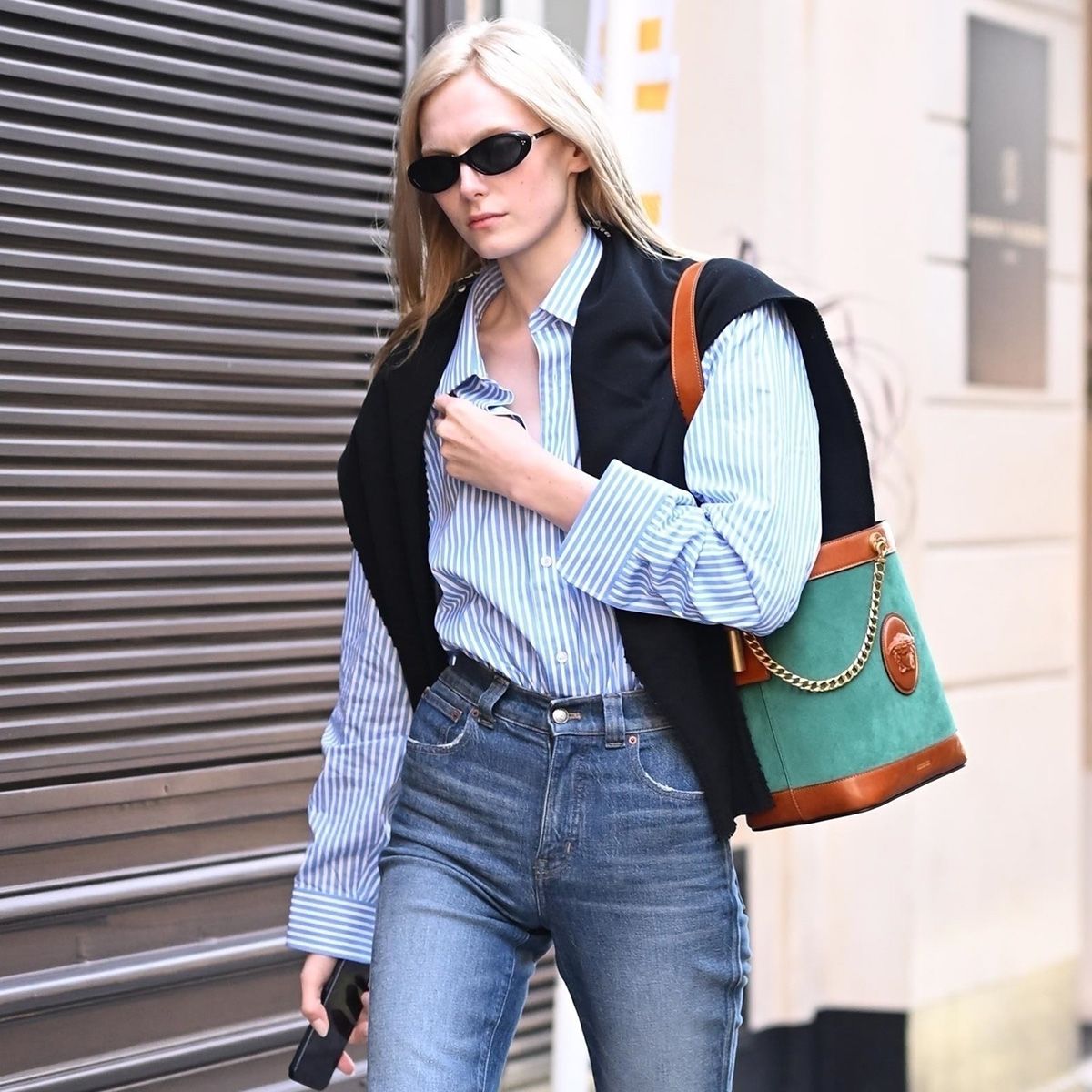 Model Alex Consani wearing cropped jeans and loafers in Paris